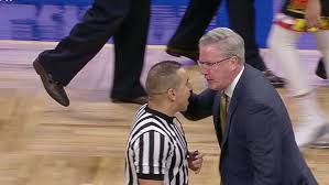 Basketball coach yelling at a referee
